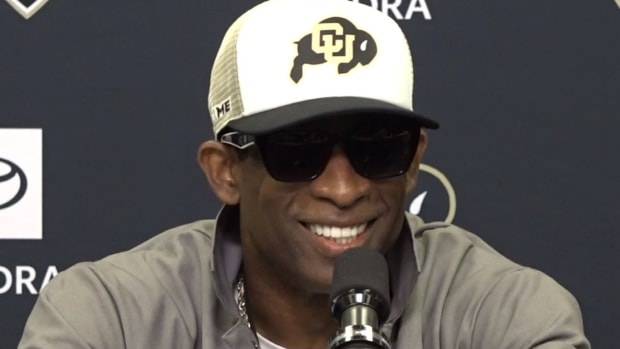Deion Sanders at the podium for CU press conference